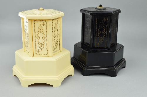 A PAIR OF SELCO BAKLITE NOVELTY MUSICAL CIGARETTE DISPENSERS, one in cream, the other in black,