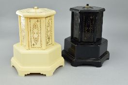 A PAIR OF SELCO BAKLITE NOVELTY MUSICAL CIGARETTE DISPENSERS, one in cream, the other in black,