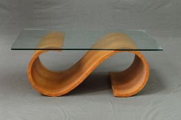 A RECTANGULAR GLASS TOPPED WAVE STYLE COFFEE TABLE, in the style of Fjords Hjellegjerde, approximate