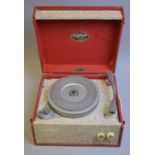 A DANSETTE POPULAR RECORD PLAYER, in red and beige finish, badge to inner lid, approximately 32cm