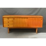 A GORDON RUSSELL OF BROADWAY TEAK SIDEBOARD, flanked by three drawers with shaped handles and double
