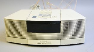 A BOSE WAVE RADIO CD, model No.AWRC3P, with a AWACP1 pedestal in white and remote control