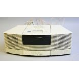 A BOSE WAVE RADIO CD, model No.AWRC3P, with a AWACP1 pedestal in white and remote control