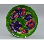 A MOORCROFT 'ANEMONE' PATTERN PLATE, in the green colourway impressed Moorcroft backstamp and