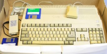 A COMMODORE AMIGA A500 VINTAGE PERSONAL COMPUTER, with power supply, mouse and workbench diskette in