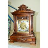 A JUNGHANS REPEATING BRACKET CLOCK, having a brass face with a silvered chapter ring and Roman