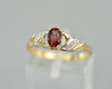 A 9CT RING SET WITH A GARNET AND DIAMONDS, ring size P, approximate weight 2.1 grams