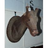 A CARVED WOOD WALL MOUNTED HORSE HEAD