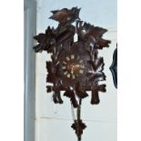 A LATE 19TH CENTURY OAK CUCKOO CLOCK, the sable with central bird flanked by leaves, the case