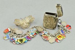 A SILVER CHARM BRACELET, and a vesta and butterfly brooch (3)