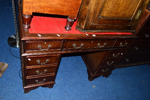A MODERN MAHOGANY PEDESTAL DESK, with red tooled leather inlay top and nine drawers, approximate