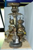 A VICTORIAN STYLE ELECTRIC LAMP BASE, decorated with cherubs, untested, missing some glass droppers