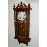 A LATE VICTORIAN CARVED OAK VIENNA WALL CLOCK, 8 day movement, metal dial with Roman numerals,