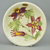A MOORCROFT POTTERY LOW DISH, 'Columbine' pattern on cream ground, impressed marks and painted