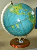 A GEORGE PHILLIPS AND SONS TERRESTRIAL GLOBE, dated 1973, with a wooden base, some discolouring to