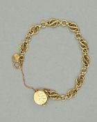 A LATE 20TH CENTURY 9CT GOLD FANCY KNOT LINK BRACELET, with two charms attached, bracelet