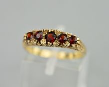 A 9CT FIVE STONE GARNET RING, ring size N, approximate weight 3.0 grams