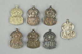 A BAG CONTAINING SEVEN SILVER HALLMARKED WWII ERA ARP BADGES