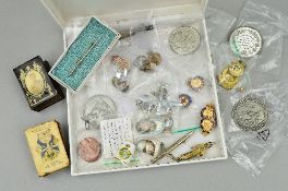 A BOX CONTAINING A NUMBER OF PIN BADGES, TIE PINS, COMMEMORATIVE COINS, all military related,