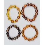 FOUR BURMESE AMBER BEAD BRACELETS, designed as expandable spherical bead bracelets, beads