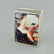 A SMALL ENAMEL PILL BOX, depicting a scantilly clad woman, stamped 'STERLING', approximate length