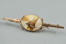 AN EARLY 20TH CENTURY 9CT CAMEO BAR BROOCH, depicting a sail boat and scroll design on the bar,