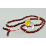 A BURMESE AMBER NECKLACE AND RING, the necklace designed as uniform beads, length 560mm, the ring