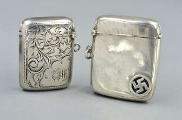 TWO SILVER VESTA CASES, the first with scrolling acanthus leaf decoration and engraved monogram,