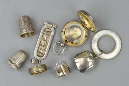 EIGHT SILVER AND WHITE METAL ITEMS, to include a late Victorian silver coin holder, two thimbles,