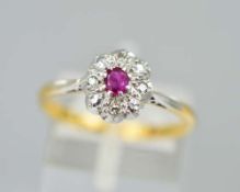 A DIAMOND AND RUBY CLUSTER RING, designed as four diamonds surrounding one central claw set