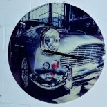 A MODERN CIRCULAR WALL CLOCK OF A VINTAGE CAR, approximate diameter 80.5cm, together with a modern