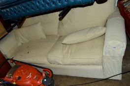 A LARGE UPHOLSTERED TWO SEATER SOFA