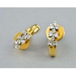 A PAIR OF 18CT DIAMOND EARRINGS, each set with nine modern round brilliant cut diamonds, on a curved