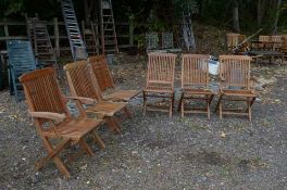 A SET OF SIX TEAK FOLDING GARDEN CHAIRS, including two carvers