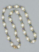 A CULTURED PEARL NECKLACE, with twenty five cultured pearls, interspaced by twenty four dyed