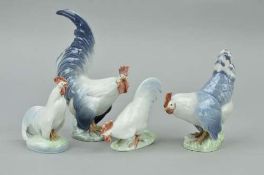TWO PAIRS OF ROYAL COPENHAGEN COCKERELS AND HENS, designed by Christian Thomsen, model numbers 1024,