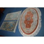 A CHINESE WOOLLEN OVAL RUG, and two similar rectangular rugs (3)