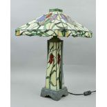 A LARGE TIFFANY STYLE TABLE LAMP, having square canopy shaped shade, central illuminated column,