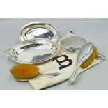 AN EARLY 20TH CENTURY THREE PIECE SILVER BACKED DRESSING TABLE SET, including hand mirror,