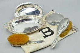 AN EARLY 20TH CENTURY THREE PIECE SILVER BACKED DRESSING TABLE SET, including hand mirror,