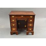 A GEORGE III MAHOGANY KNEE-HOLE DESK, the rectangular top with moulded edge above a single long