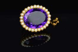 AN EARLY 20TH CENTURY LARGE OVAL AMETHYST AND SPLIT PEARL BROOCH, measuring approximately 33mm x