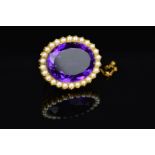 AN EARLY 20TH CENTURY LARGE OVAL AMETHYST AND SPLIT PEARL BROOCH, measuring approximately 33mm x