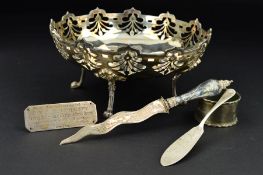 A GEORGE V CIRCULAR SILVER DISH WITH CRENELLATED RIM ABOVE FOLIATE PIERCED BORDER, on four