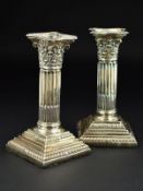 A PAIR OF LATE VICTORIAN CANDLESTICKS, the removable sconces of shaped square outline above