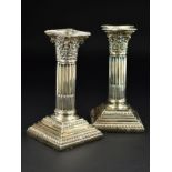 A PAIR OF LATE VICTORIAN CANDLESTICKS, the removable sconces of shaped square outline above