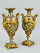 A PAIR OF 19TH CENTURY ORMOLU AND CHAMPLEVE TWIN HANDLED URNS, of baluster form with bearded male