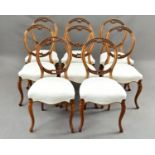 A MATCHED SET OF EIGHT VICTORIAN WALNUT BALLOON BACK DINING CHAIRS, with carved foliate and scroll