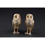 A PAIR OF ELIZABETH II NOVELTY SILVER OWL SALT AND PEPPER POTS, glass eyes, makers Period