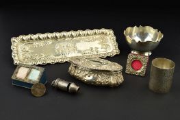 AN EDWARDIAN RECTANGULAR SILVER DRESSING TABLE TRAY, with embossed wavy lobed rim, the centre with